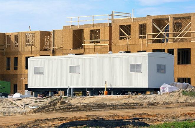 workers studying blueprints in a temporary rental office in Poway